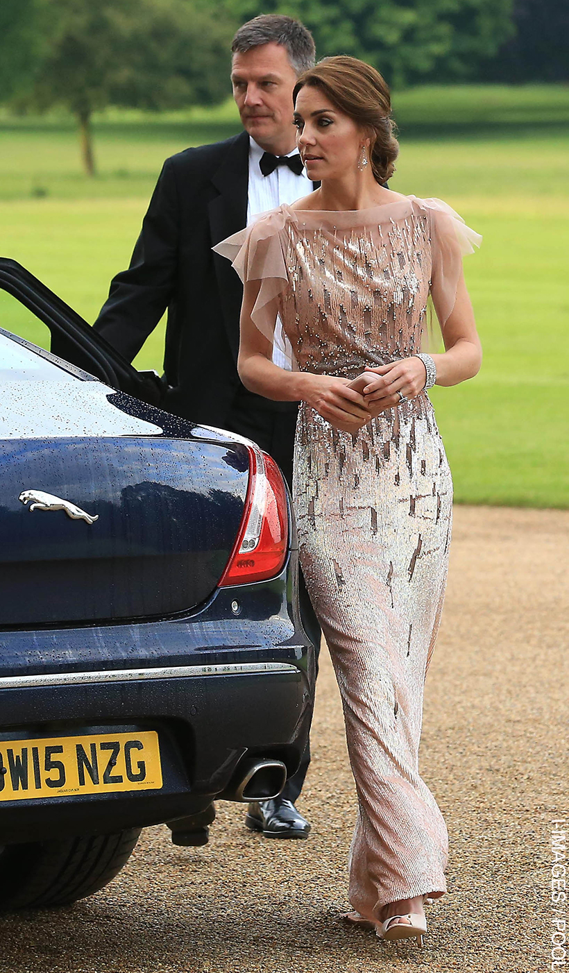 Kate wearing the pink pearlescent gown as she arrives at the 2016 EACH gala. She wears her hair tied up and chandelier earrings.
