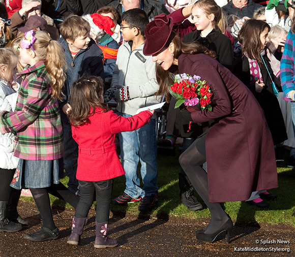 The Duchess of Cambridge wears an aubergine coloured dress