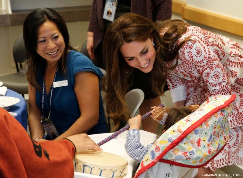 Kate cooing over a baby at Sheway, Vancouver