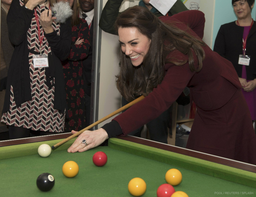Britain's Catherine, Duchess of Cambridge, plays pool during her visit to MIST, a child and adolescent mental health project in Pontypool