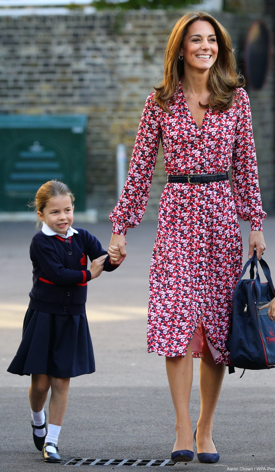 Kate Middleton takes Princess Charlotte to school for her first day. The Duchess is wearing a pink floral dress.