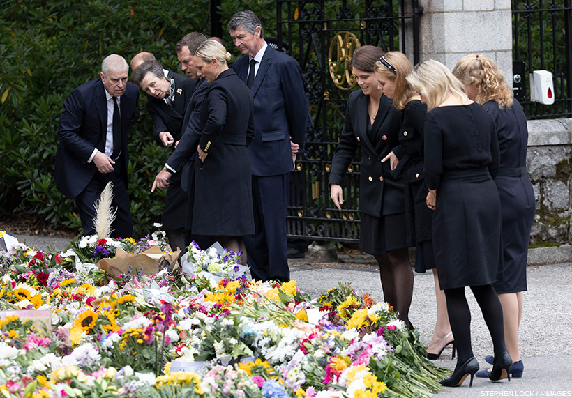 Royals looking at flowers outside of Balmoral