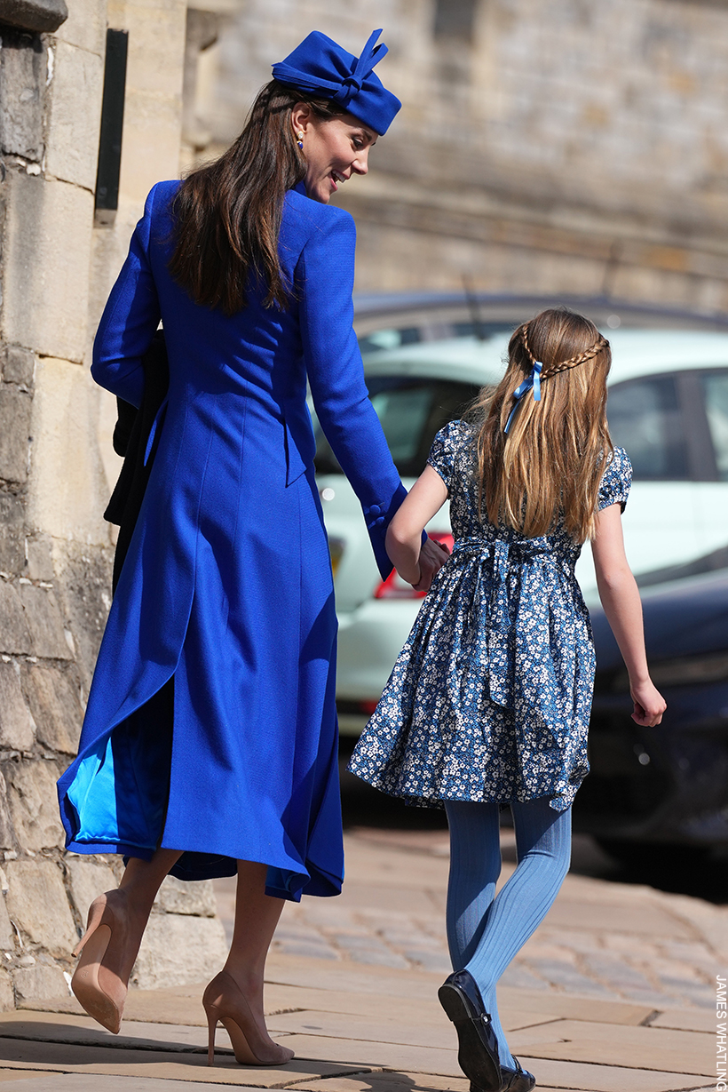 Kate walks away from the service holding Princess Charlotte's hand