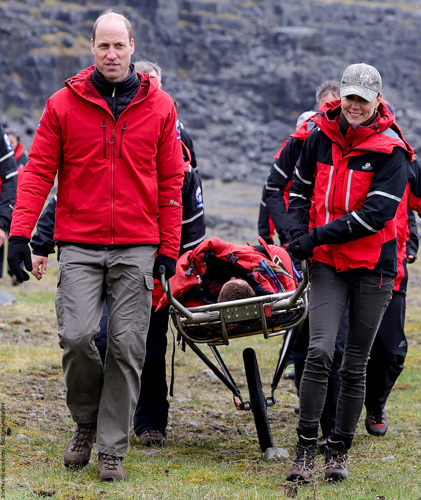 William and Kate take part in a mountain rescue training session in Wales. The pair are trying to move a person pretending to be injured.