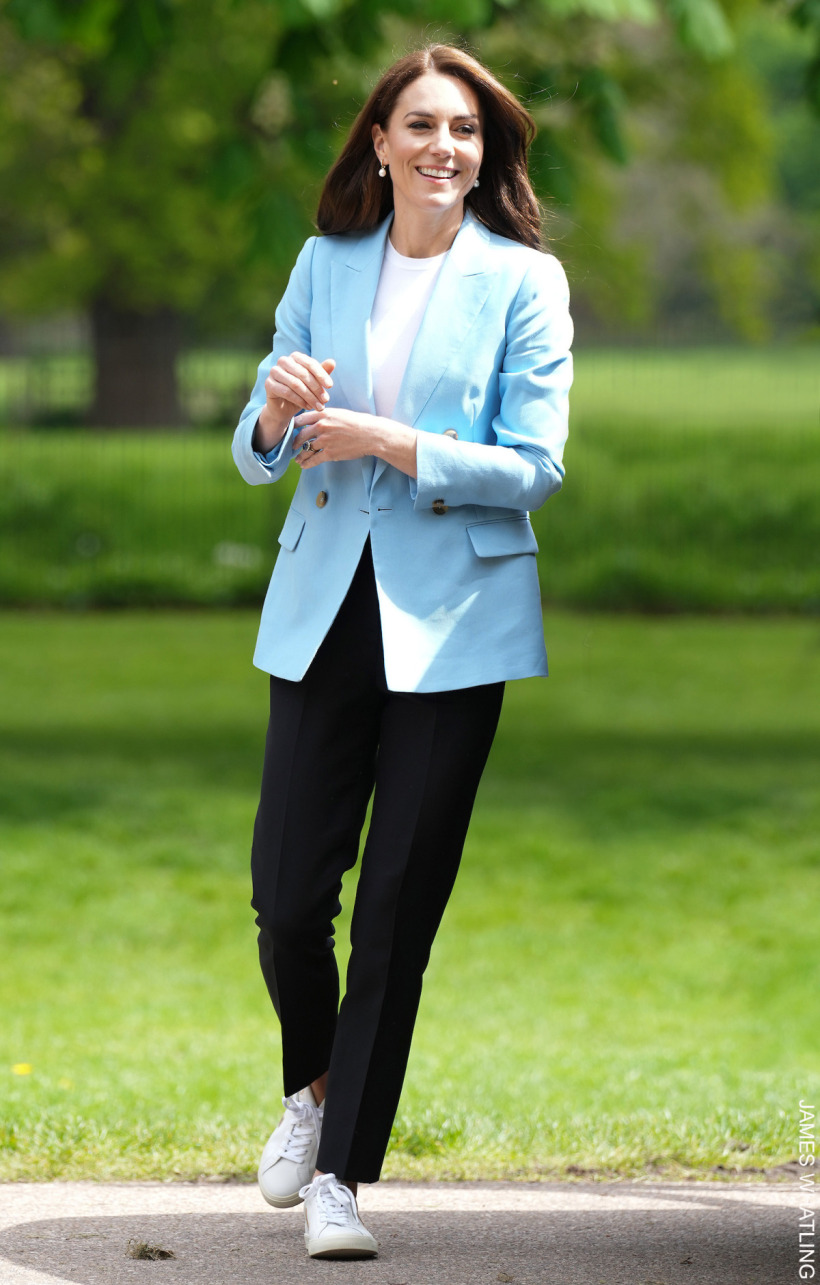 Kate Middleton at The Big Lunch on the long walk in Windsor, wearing a baby blue blazer with trousers and trainers. A casual-chic look.