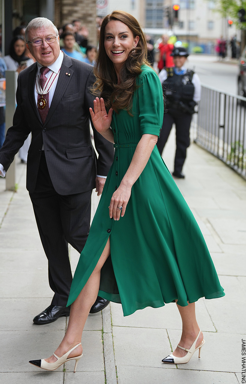 Kate Middleton, the Princess of Wales, walking, wearing a green dress and contrasting slingback heels