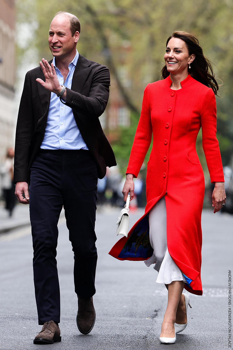 The very chic Princess of Wales in her red coat, walking with her husband, the equally dapper Prince of Wales in his suit.