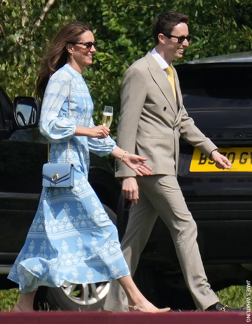 Kate Middleton walks, wearing a blue maxi dress while carrying the light blue Mulberry Harlow handbag on her shoulder