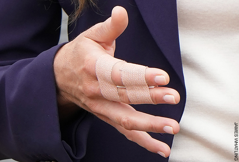 Kate Middleton's fingers taped up following a trampoline accident. Index and middle finger are taped together with flesh coloured plasters.