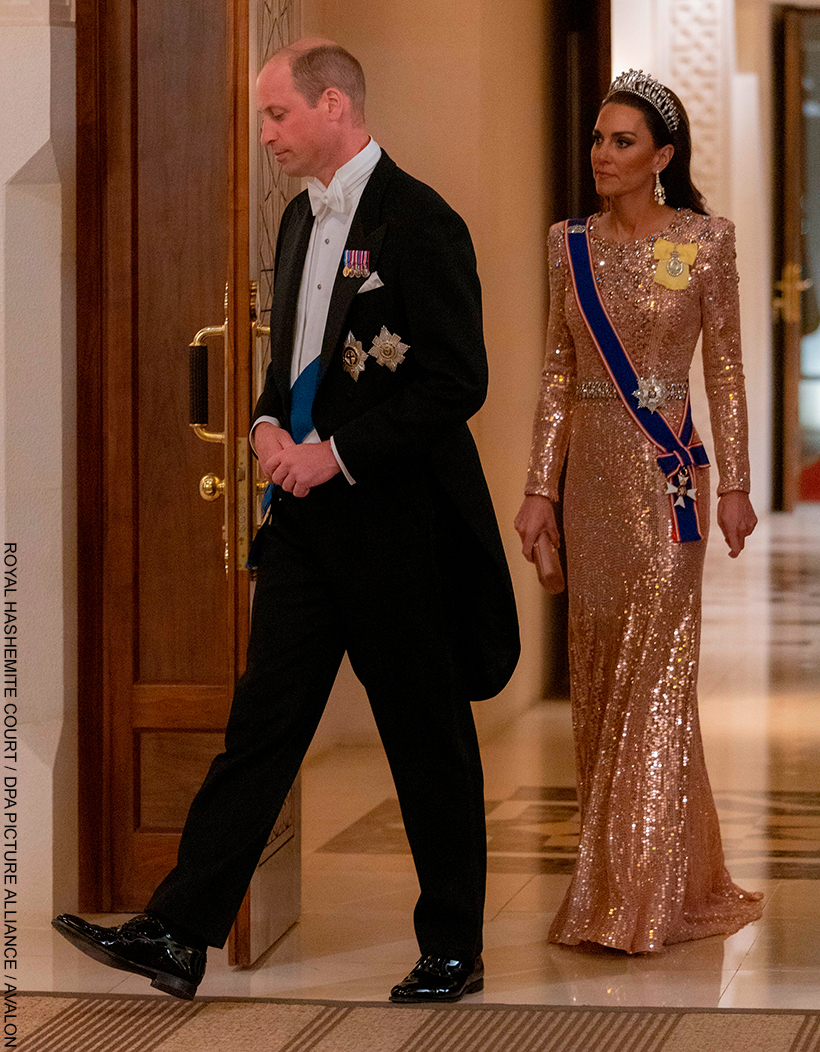 Kate Middleton chatting with guests at the Jordan Royal Wedding in 2023. She wears the Queen Mary Lover's Knot Tiara with a shimmering pink gown.