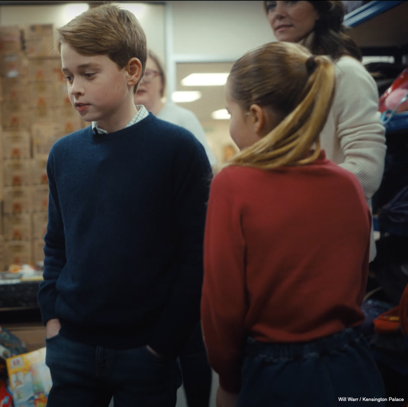 George has his hands in his pocket, charlotte has her back to the camera, Kate is in the background