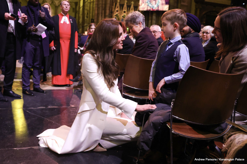 Kate Middleton joins a child in front of a church during the Royal Carols: Together at Christmas concert