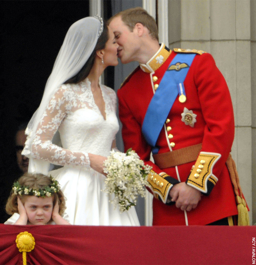 On their wedding day, the newlywed couple kiss on the balcony of Buckingham Palace.