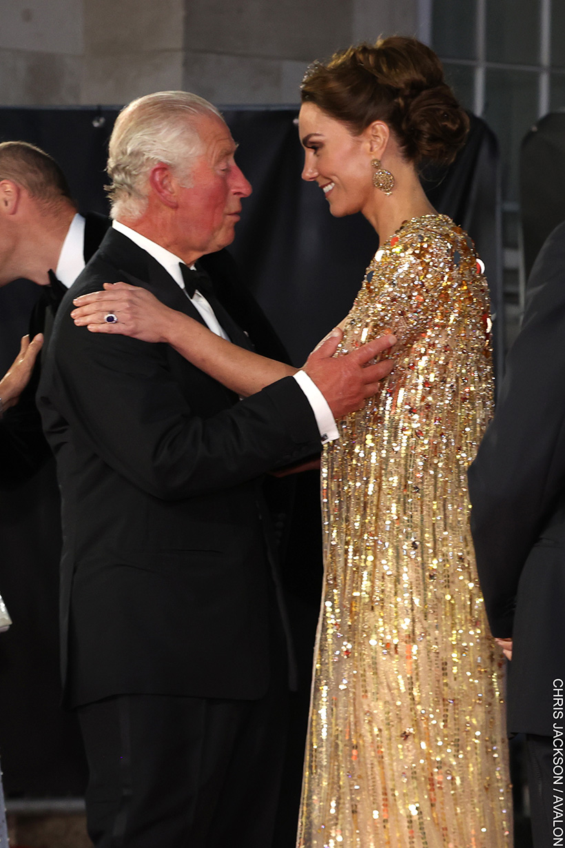 King Charles and The Princess of Wales embrace. Both are wearing formal ensembles.