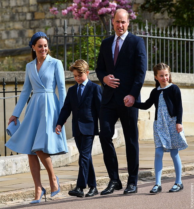 Kate Middleton wearing a pastel blue Emilia Wickstead coat dress with Jane Taylor headband at Easter service in 2022. She's accompanied by her husband Prince William, Prince George and Princess Charlotte.