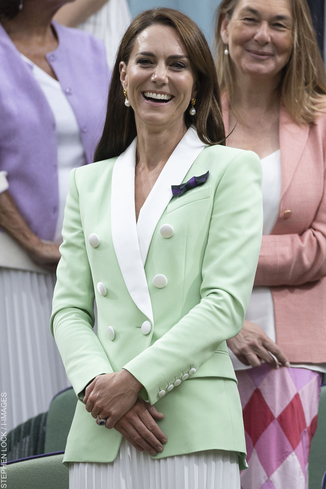 Kate Middleton wearing the Balmain bclazer, pearl earrings and a purple Wimbledon ribbon.