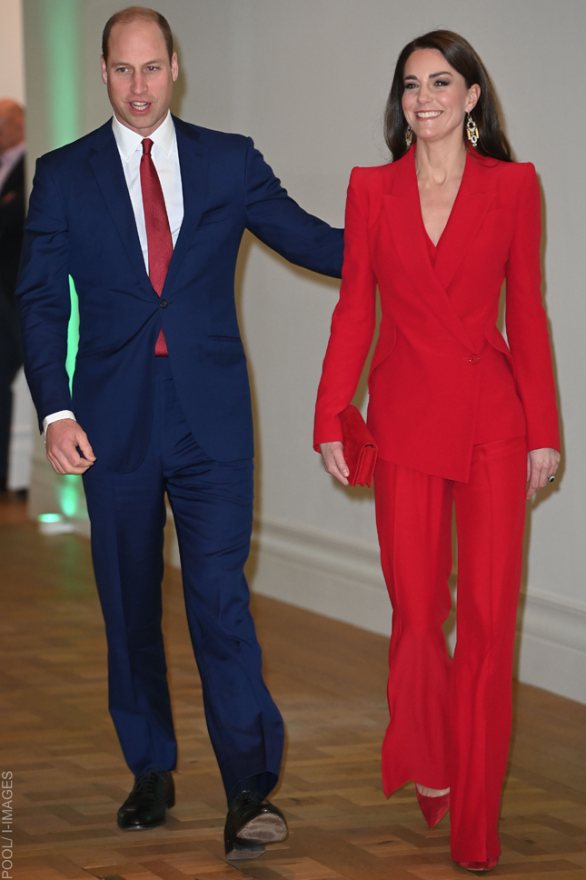 Kate Middleton wearing a red Alexander McQueen power suit with flared trousers at the Shaping Us campaign launch in London.