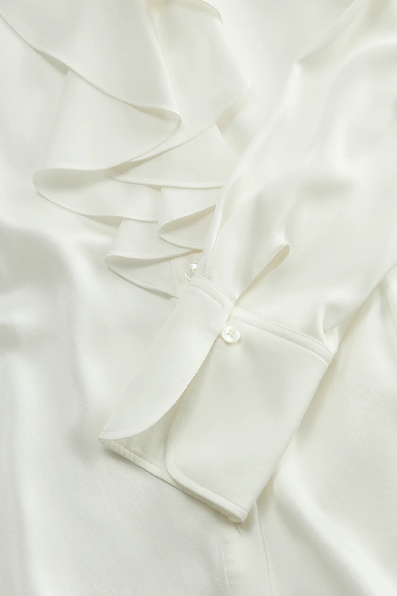 Close up of the ruffled silk blouse