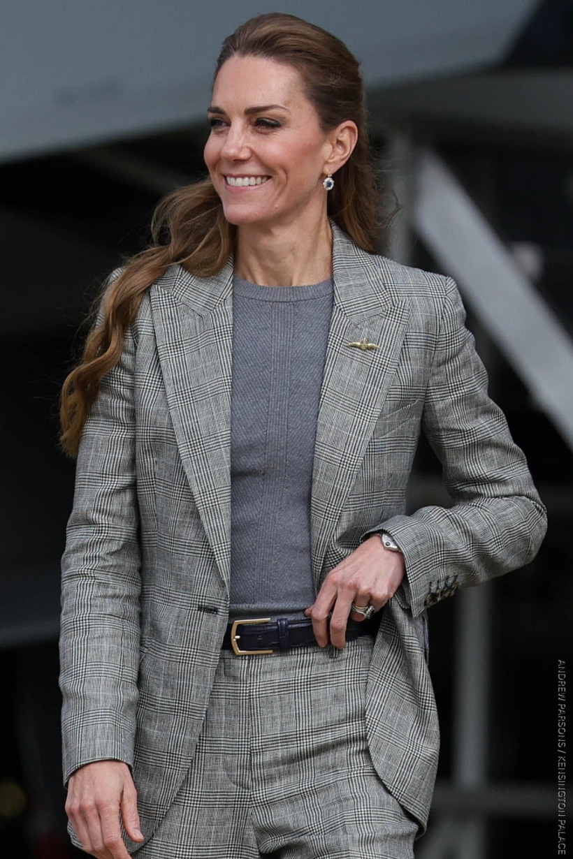 The Princess of Wales wearing a grey fine net sweater underneath a Prince of Wales check blazer