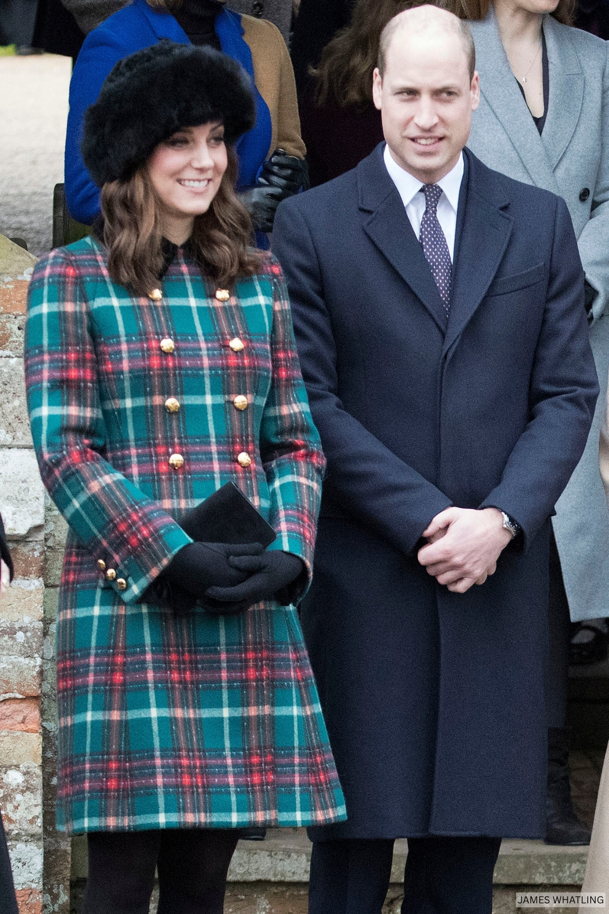 The Princess of Wales wearing a double breasted red and green tartan coat with black accessories and black fur hat
