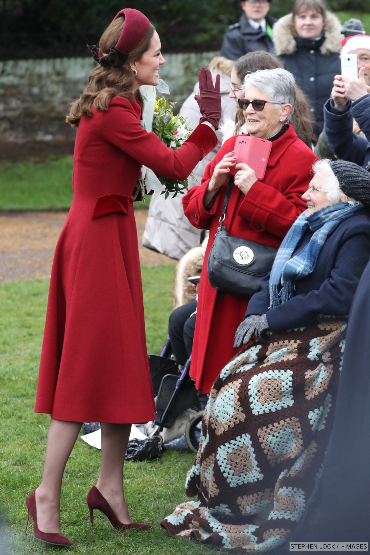 The Princess of Wales wearing a red outfit while chatting to well-wishers on Christmas Day 2018