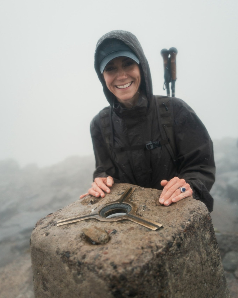 Kate Middleton wearing a cap and waterproof coat at the summit of Ben Nevis during the Three Peaks Challenge