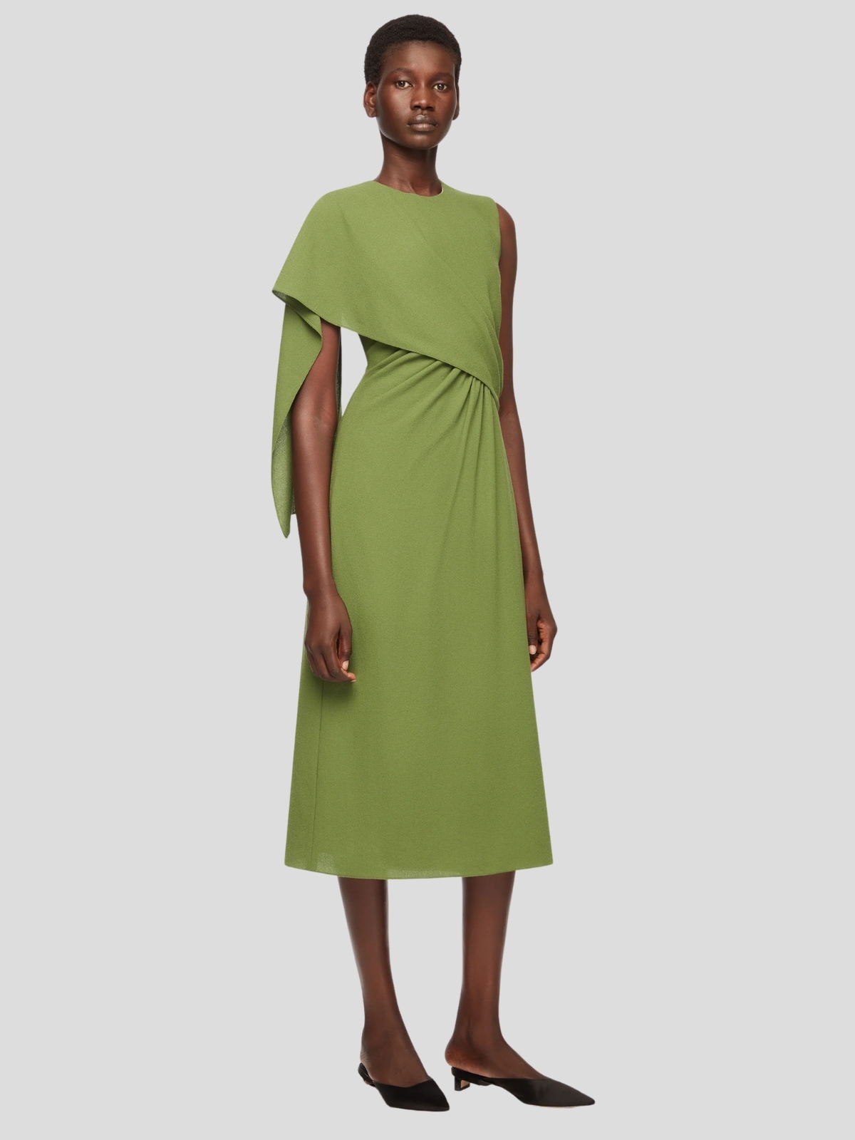 A model wearing the Emilia Wickstead Tidus dress in olive green