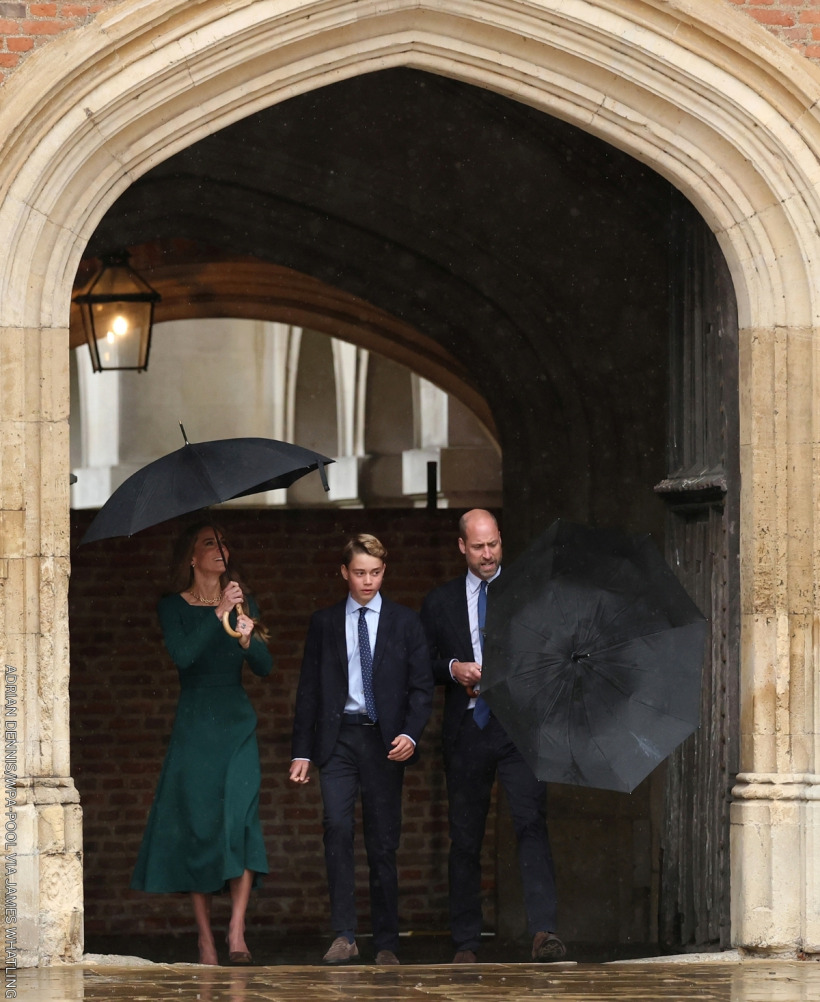 Prince William, Kate Middleton and Prince George arriving at Eton College for George's first day—William struggles with his umbrella.